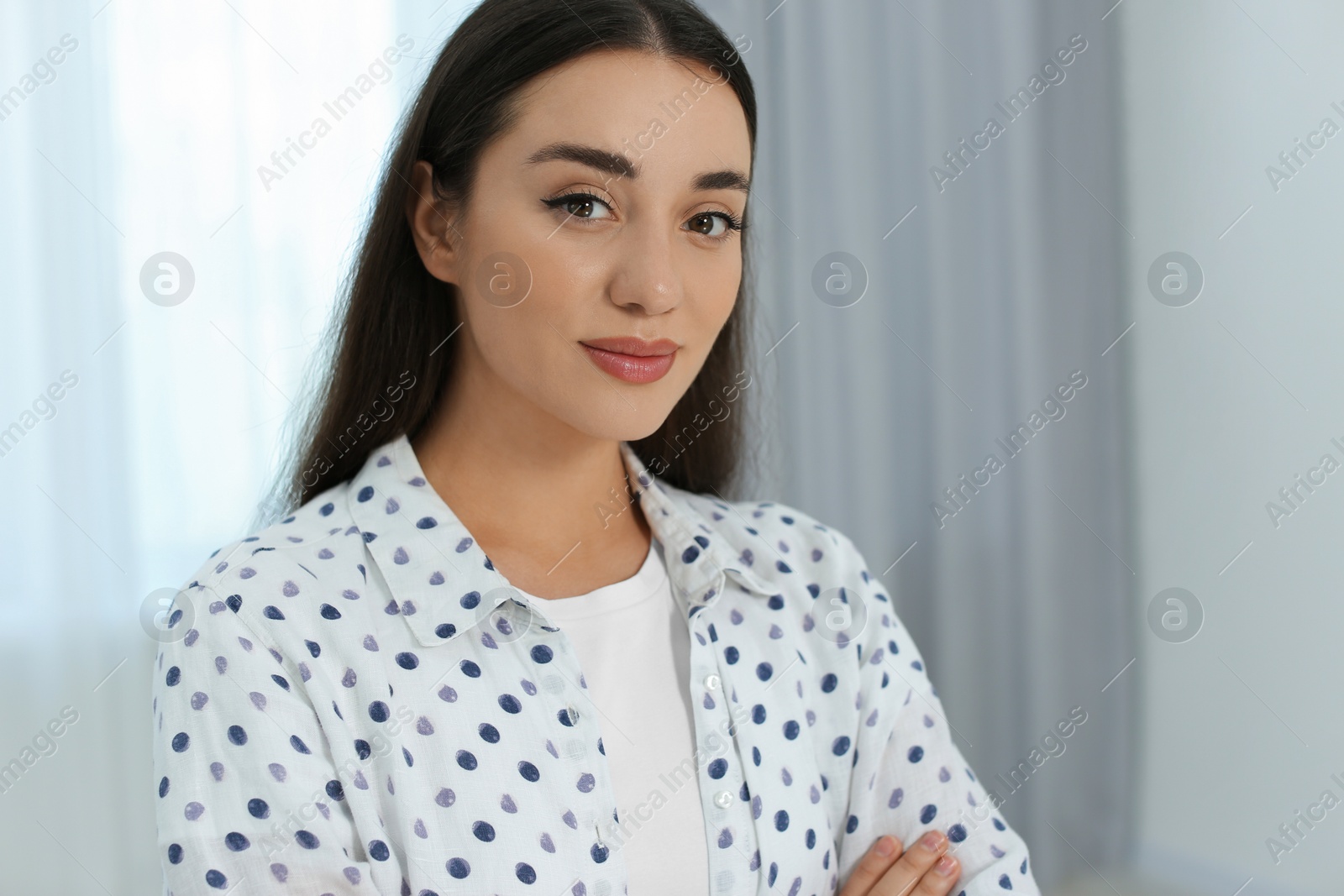 Photo of Portrait of beautiful young woman at home. Space for text