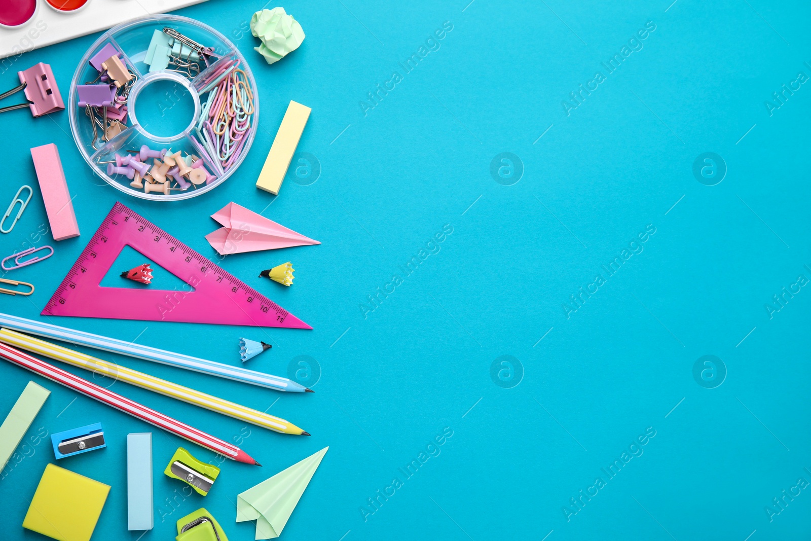 Photo of Different school stationery items on light blue background, flat lay with space for text. Back to school