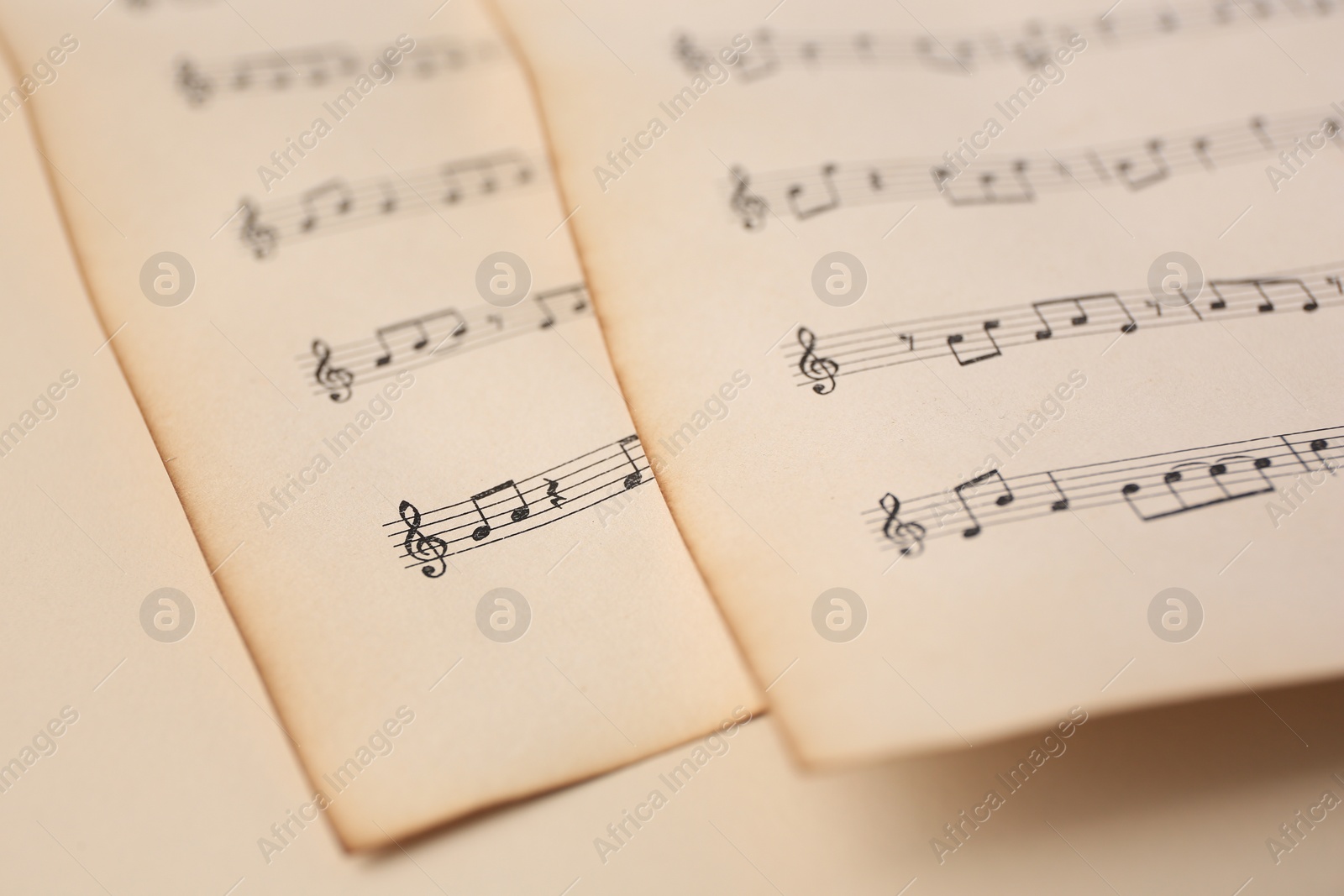 Photo of Sheets of paper with different notes on beige background, closeup