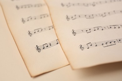 Photo of Sheets of paper with different notes on beige background, closeup