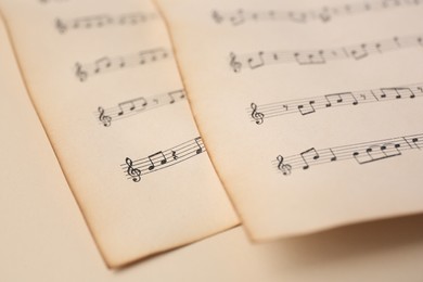 Sheets of paper with different notes on beige background, closeup