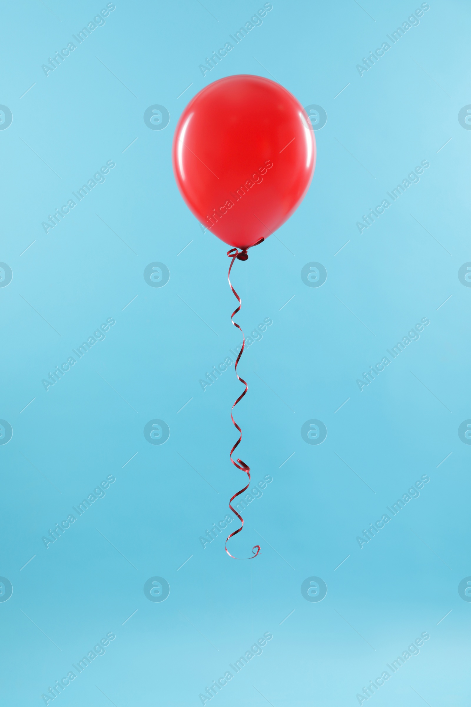 Photo of Bright balloon on color background. Celebration time