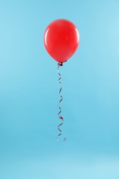 Bright balloon on color background. Celebration time