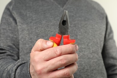 Photo of Man with color combination pliers, closeup view