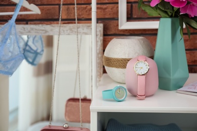 Photo of Table with beautiful wristwatches in dressing room