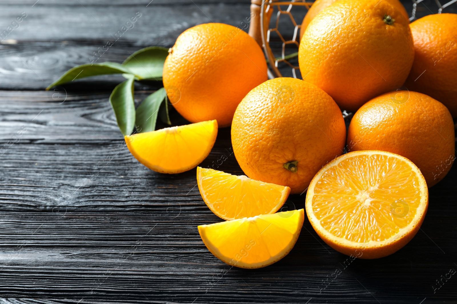 Photo of Fresh ripe oranges on wooden background. Space for text