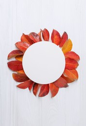 Photo of Flat lay composition with blank card and autumn leaves on white wooden table. Space for text