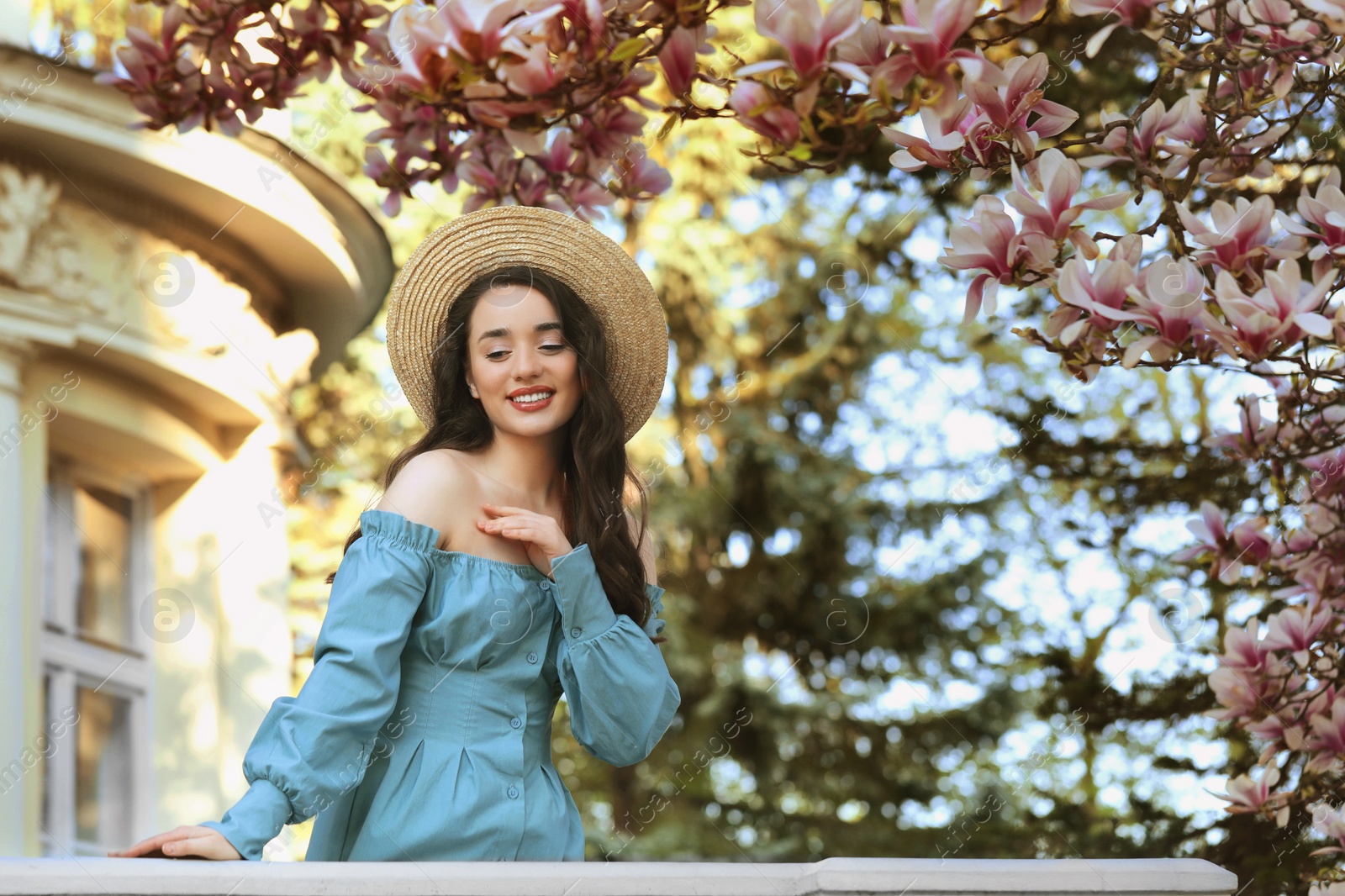 Photo of Beautiful woman near blossoming magnolia tree on spring day