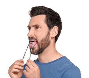Handsome man brushing his tongue with cleaner on white background
