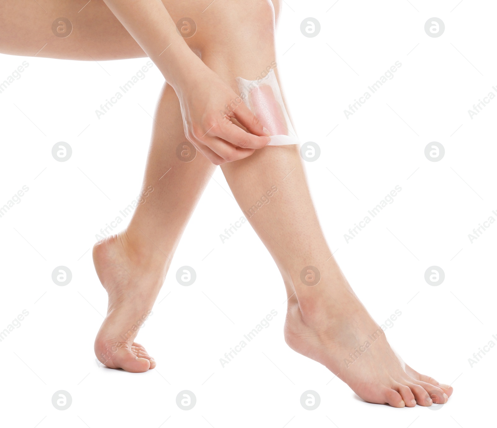 Photo of Woman doing leg epilation procedure with wax strips isolated on white, closeup