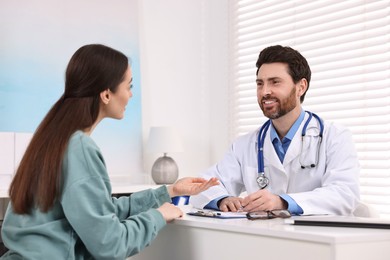 Doctor consulting patient during appointment in clinic