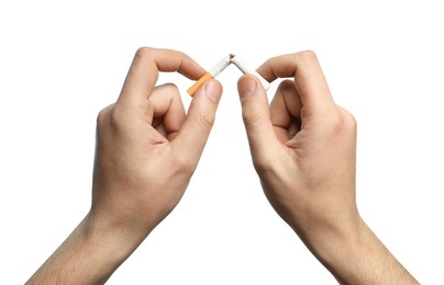 Photo of Stop smoking. Man holding broken cigarette on white background, closeup