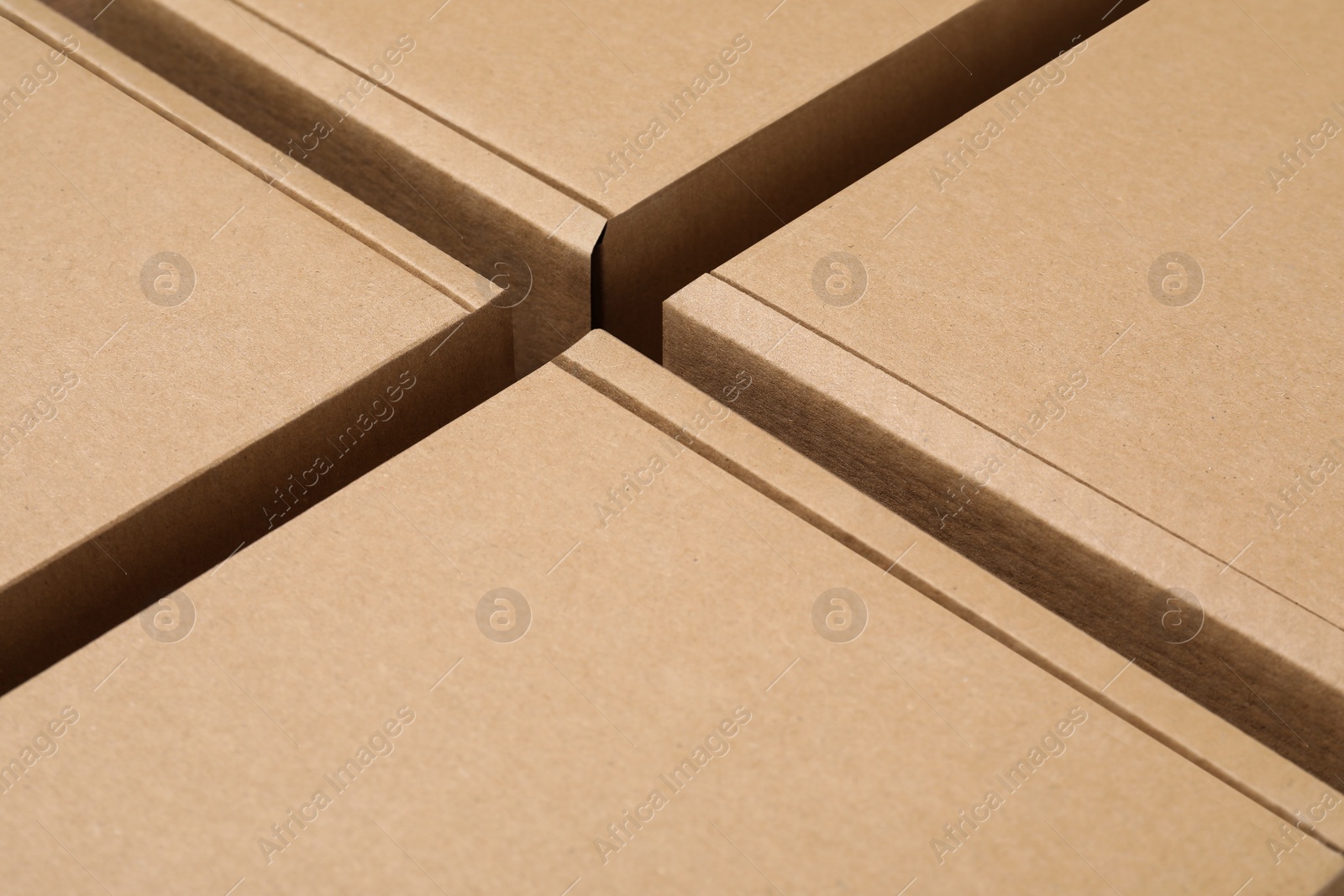 Photo of Closed cardboard boxes as background, closeup. Packaging goods
