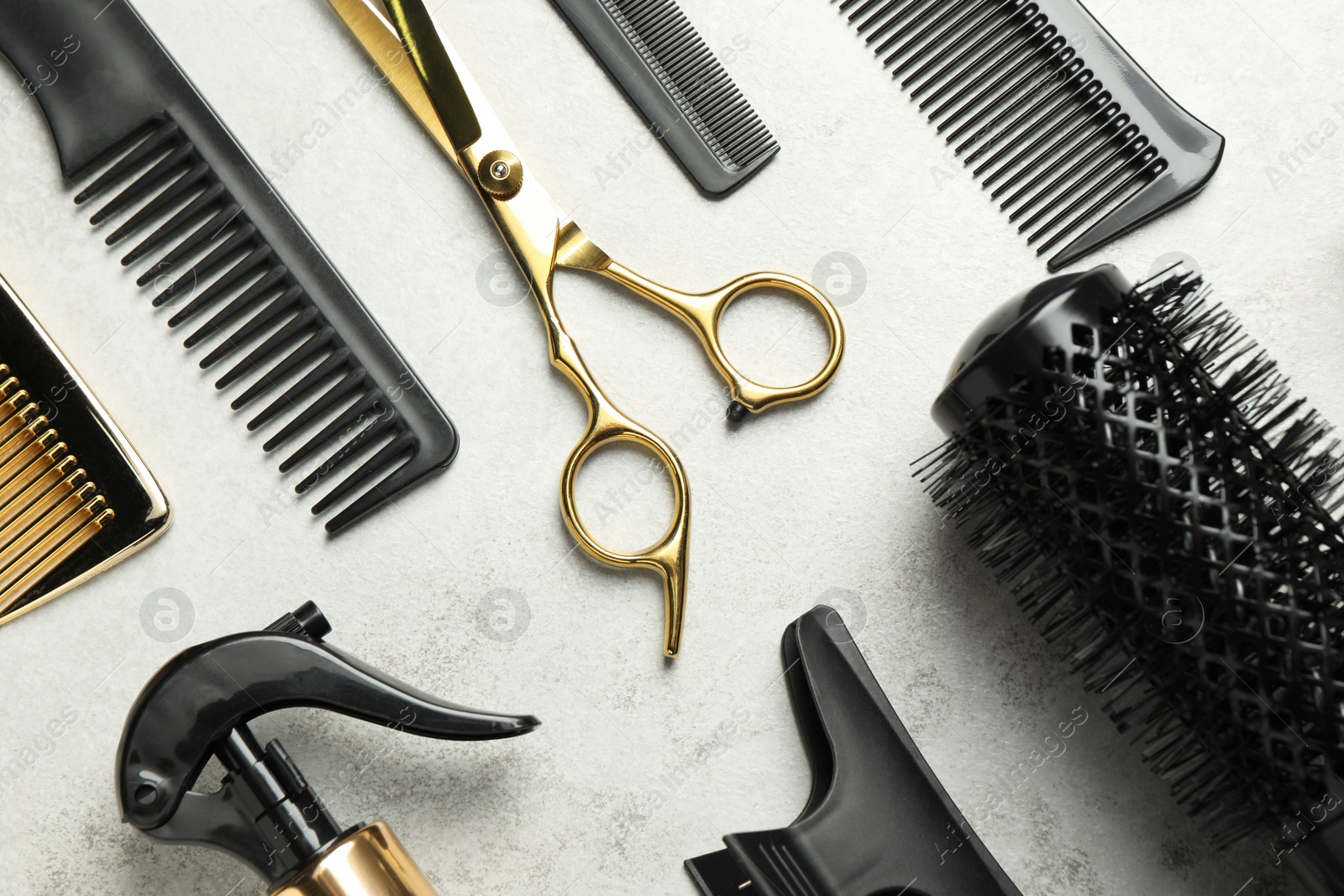 Photo of Hairdressing tools on light background, flat lay