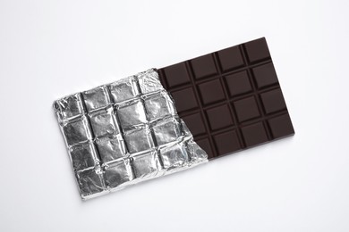 Delicious dark chocolate bar on white background, top view