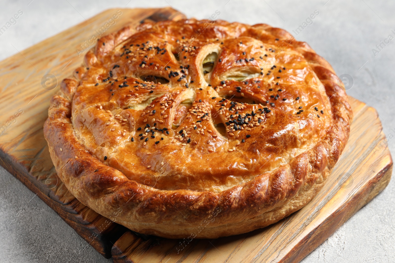 Photo of Tasty homemade pie with filling on light grey table