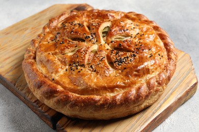 Photo of Tasty homemade pie with filling on light grey table