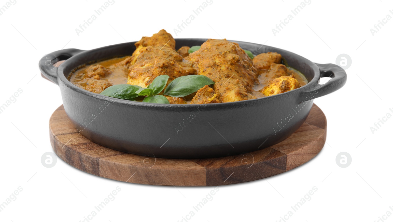 Photo of Delicious chicken with curry sauce and basil isolated on white