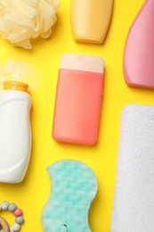 Flat lay composition with baby cosmetic products on yellow background