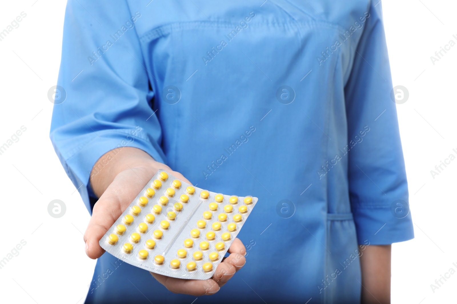 Photo of Female doctor holding pills on white background, closeup. Medical object