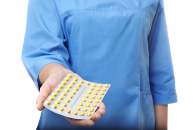 Photo of Female doctor holding pills on white background, closeup. Medical object