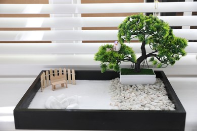 Photo of Beautiful miniature zen garden on window sill