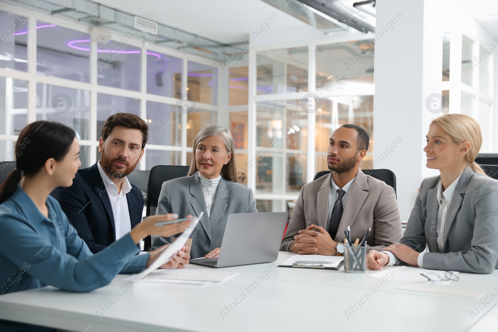 Photo of Lawyers working together at table in office