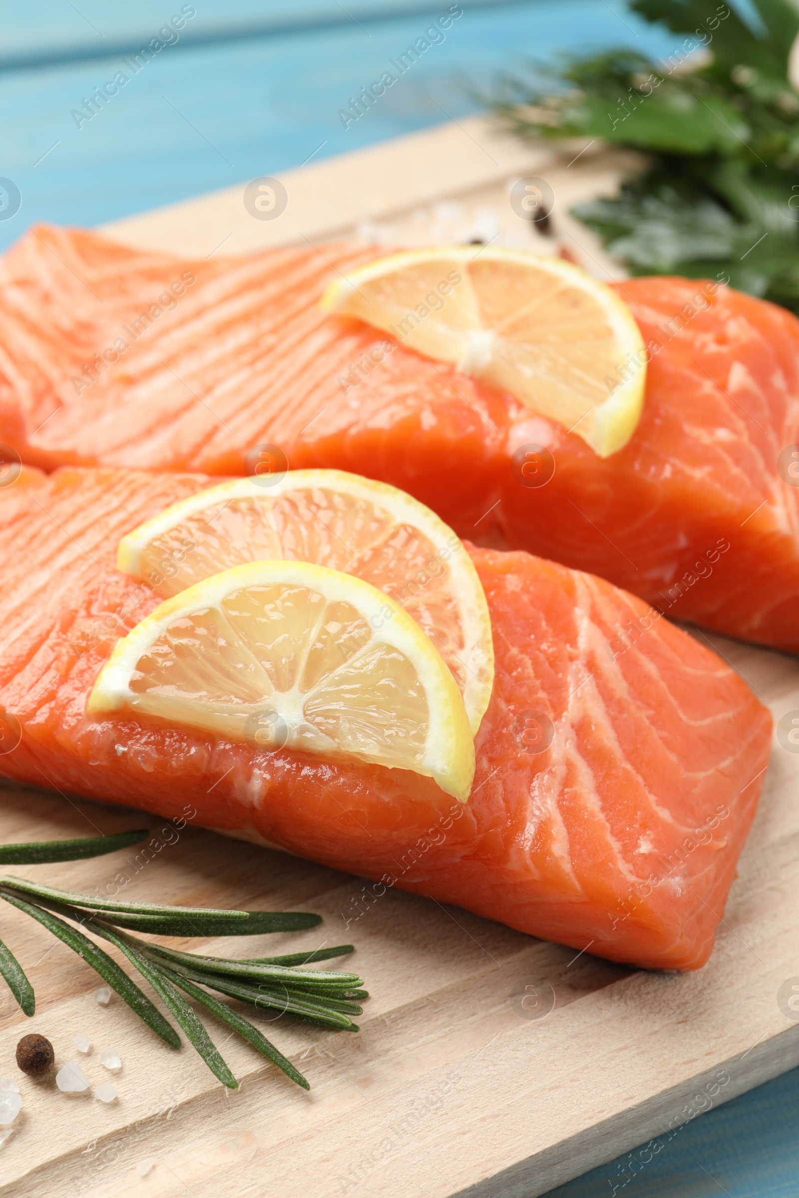 Photo of Fresh salmon and ingredients for marinade on wooden board, closeup