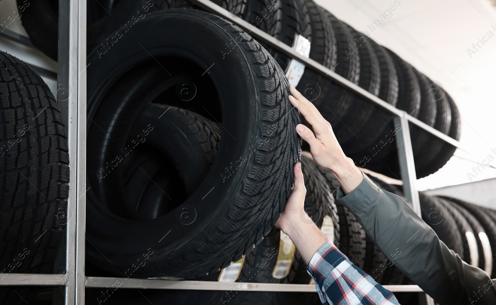 Photo of Service center consultant helping customer to choose tire in store