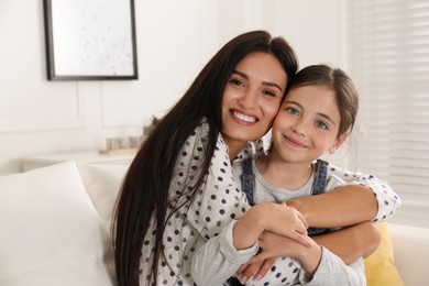 Photo of Portrait of happy mother and daughter hugging at home. Single parenting