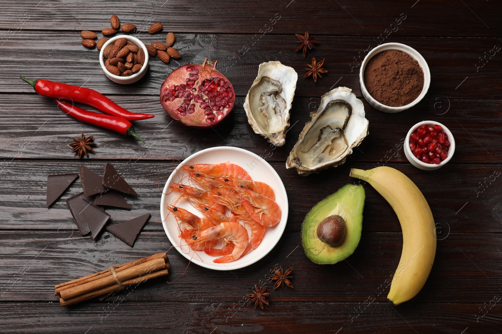 Photo of Natural aphrodisiac. Different food products on dark wooden table, flat lay