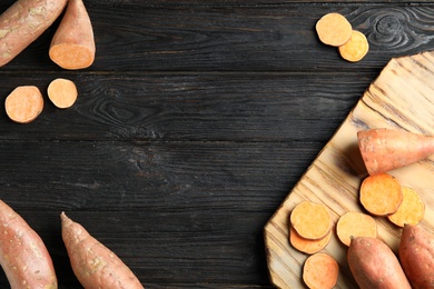 Photo of Flat lay composition with sweet potatoes and space for text on wooden background