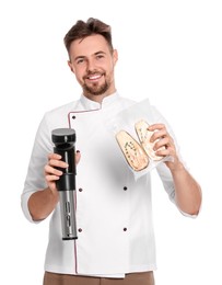 Photo of Smiling chef holding sous vide cooker and eggplant in vacuum pack on white background
