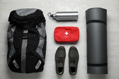Photo of Flat lay composition with different camping equipment on light background