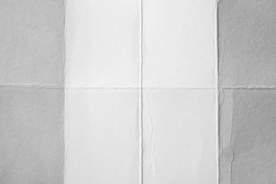 Photo of Blank white paper sheet with creases as background, closeup
