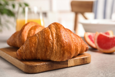 Tasty fresh croissants on light grey table. Healthy breakfast