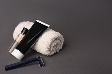 Different men's shaving accessories on grey background, space for text
