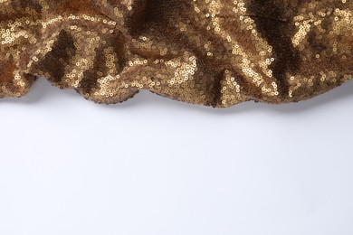 Golden shiny sequin fabric on white background. Space for text
