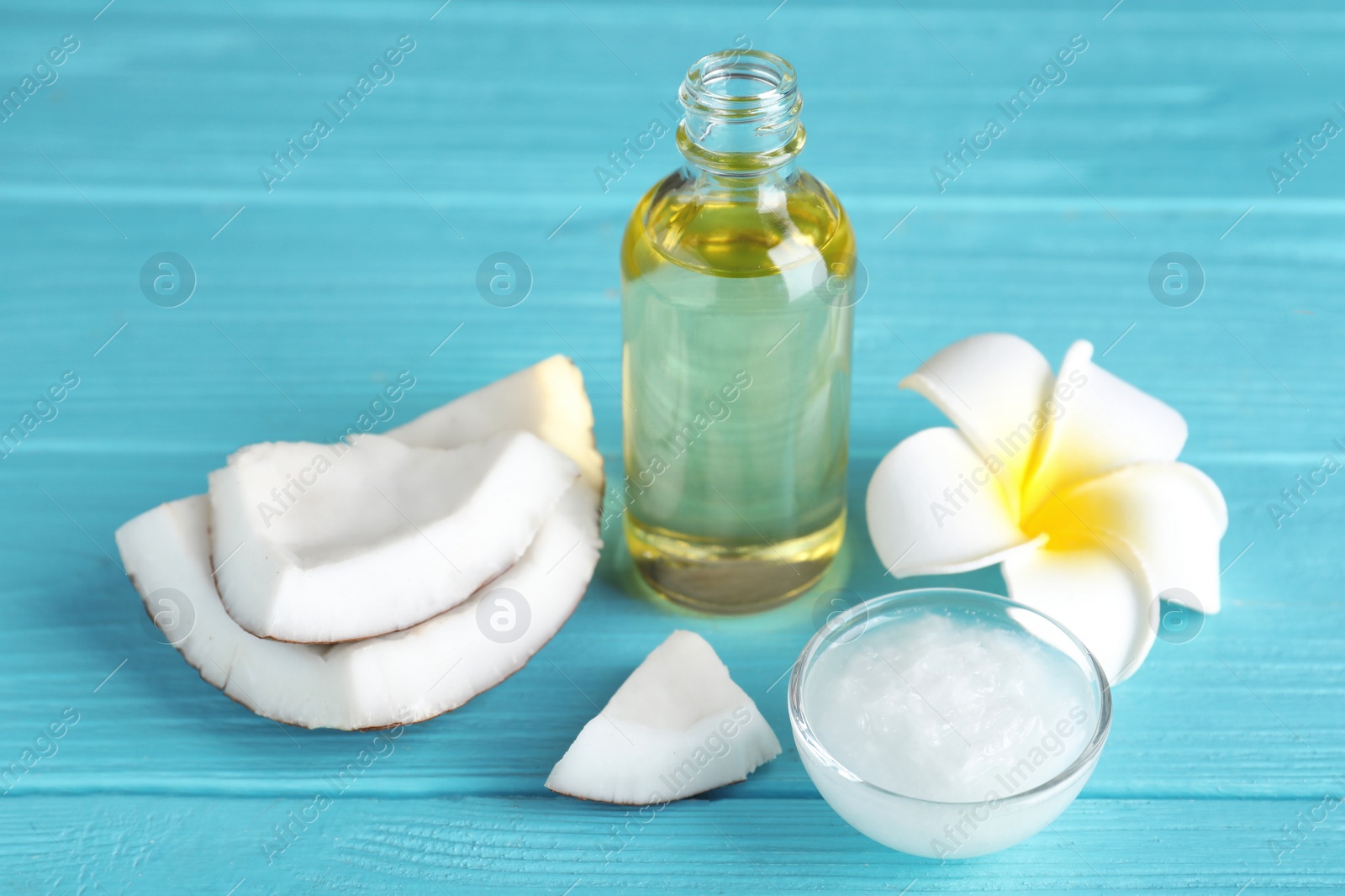 Photo of Composition with natural organic coconut oil on color wooden table