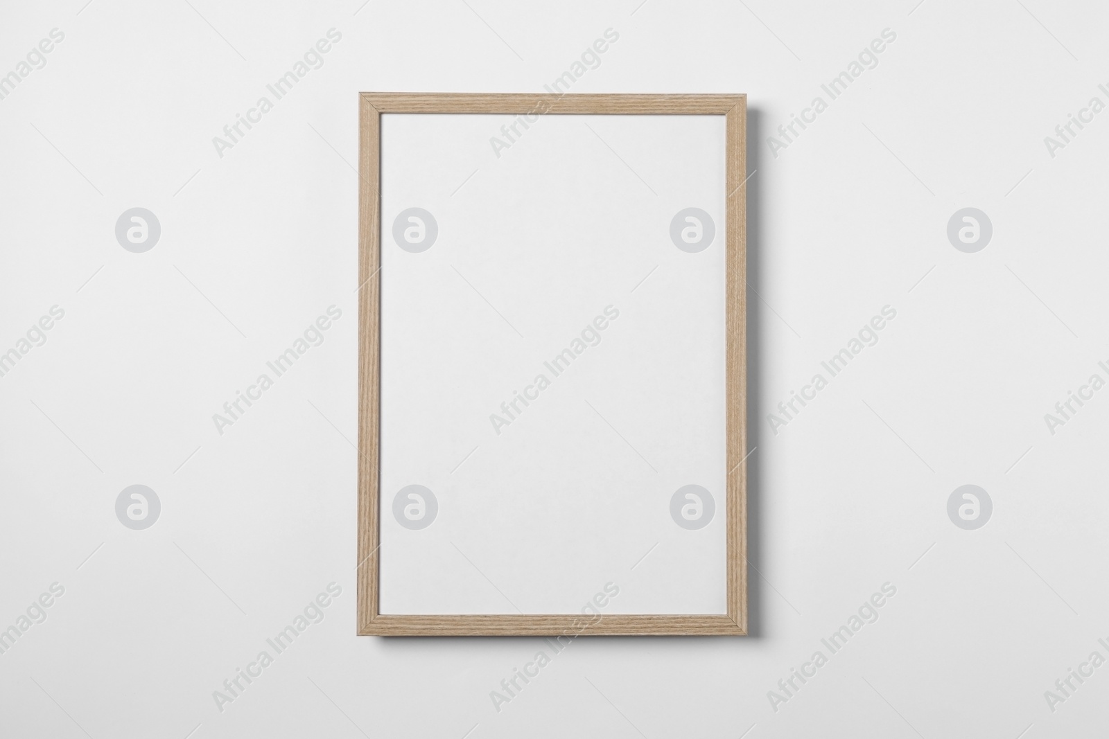 Photo of Empty wooden frame on white background. Mockup for design