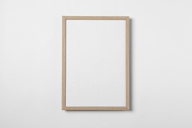 Empty wooden frame on white background. Mockup for design