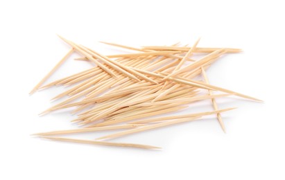 Heap of wooden toothpicks on white background