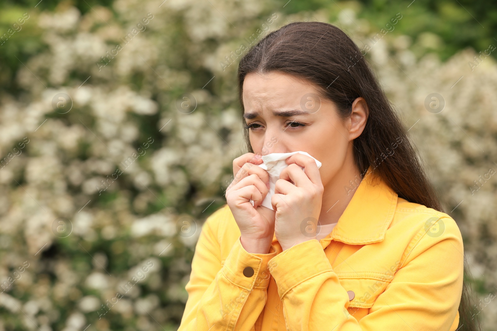 Photo of Woman suffering from seasonal spring allergy outdoors