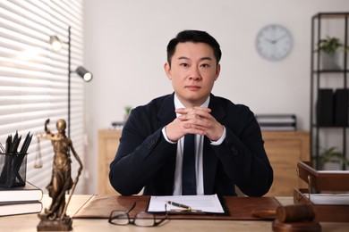 Photo of Notary working at wooden table in office