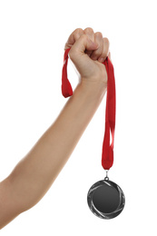 Woman holding silver medal on white background, closeup. Space for design