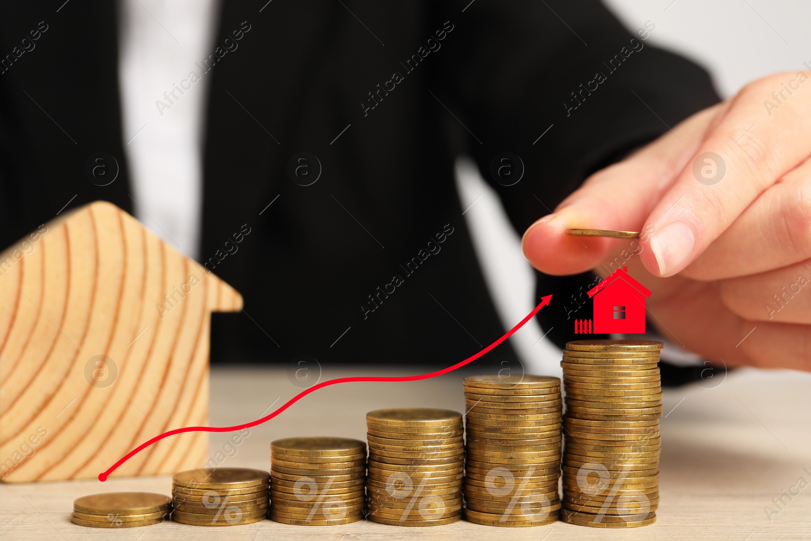 Image of Mortgage rate. Woman stacking coins on table, closeup. Arrow and model of house