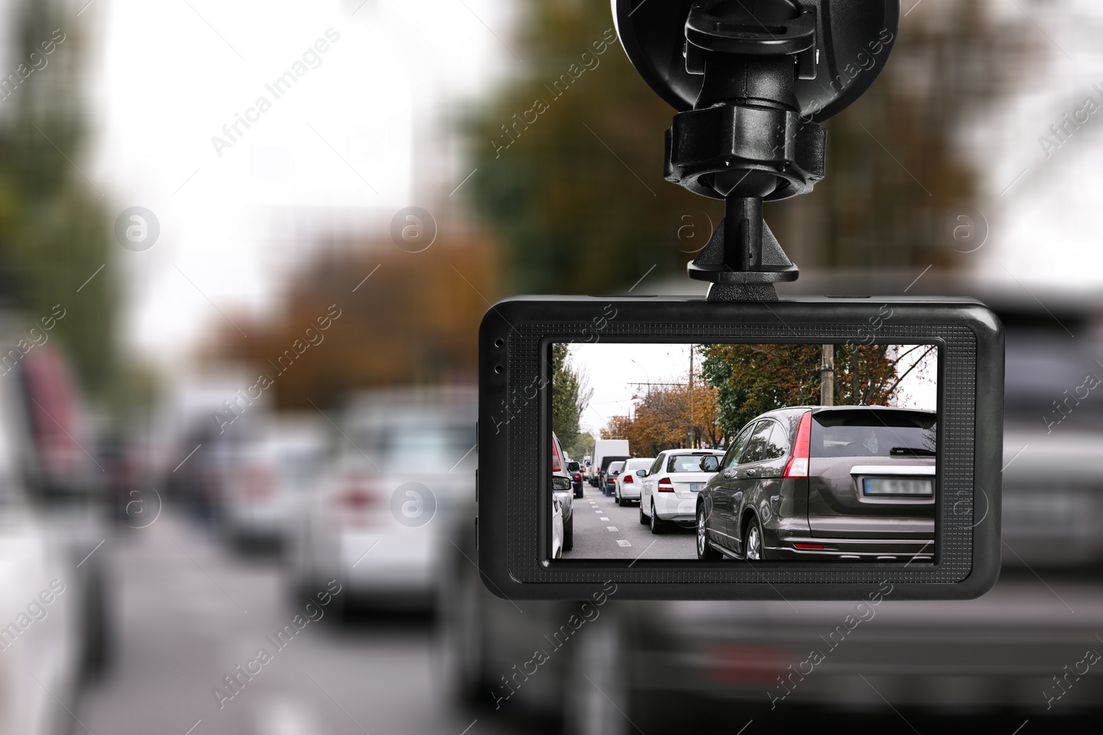 Image of Modern dashboard camera mounted in car, view of road during driving