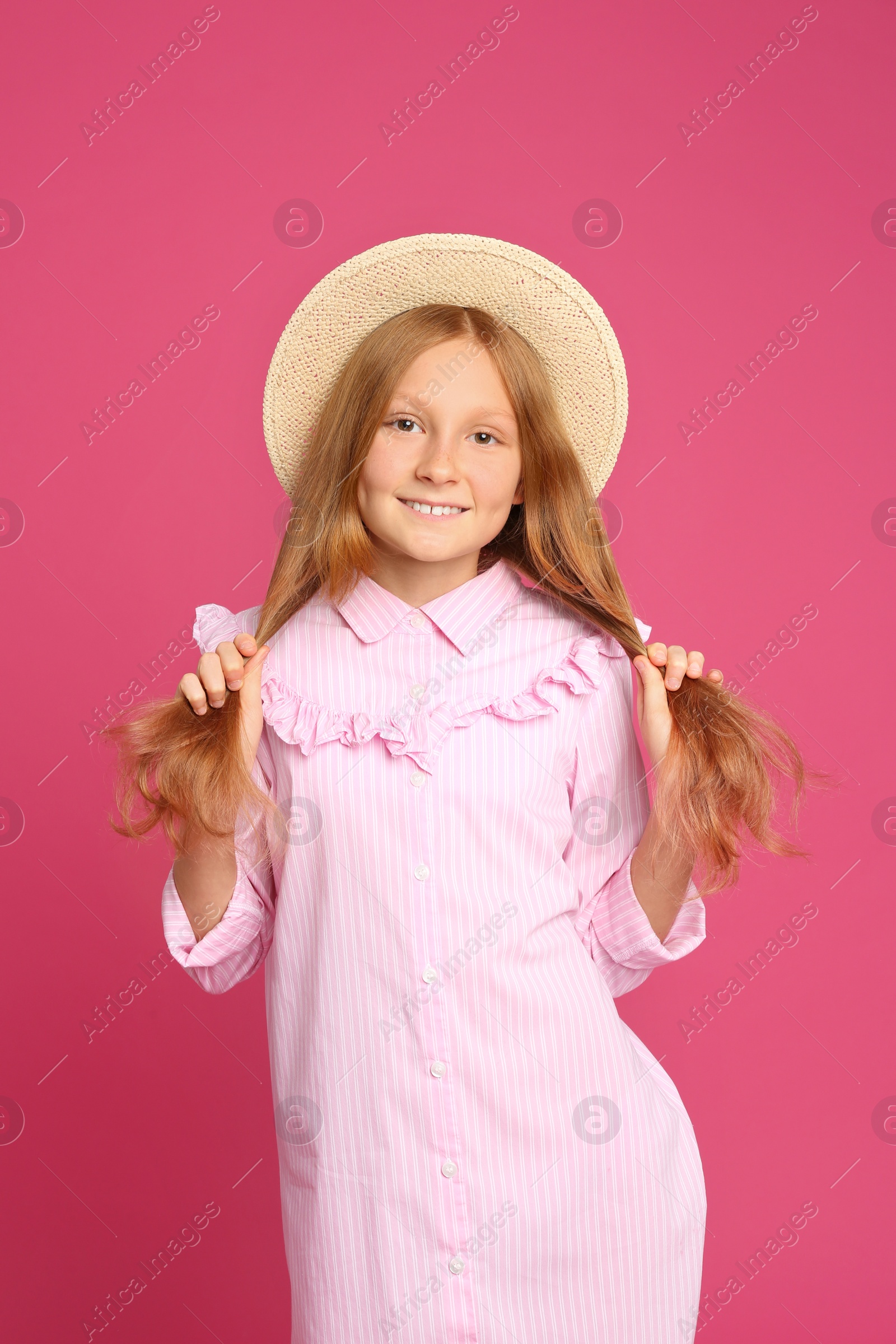 Photo of Portrait of preteen girl in hat on pink background