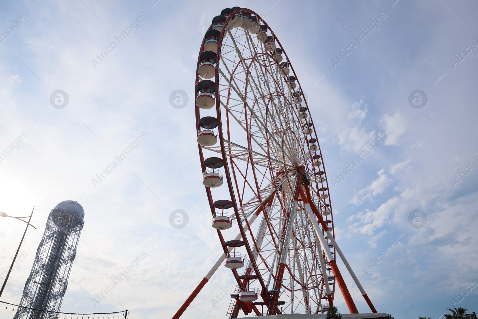 Photo of BATUMI, GEORGIA - MAY 31, 2022: Beautiful Ferris wheel outdoors, low angle view