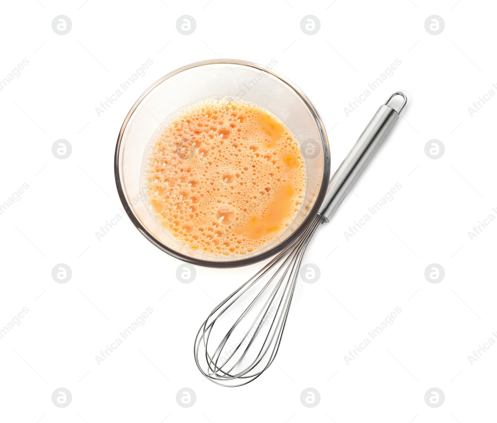 Photo of Beaten eggs in glass bowl and whisk isolated on white, top view